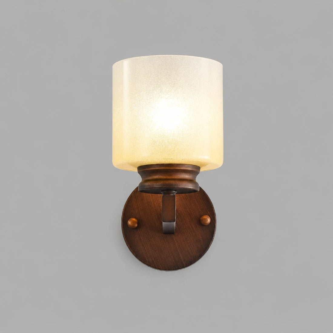 Front view of lit aged bronze alabaster glass wall sconce