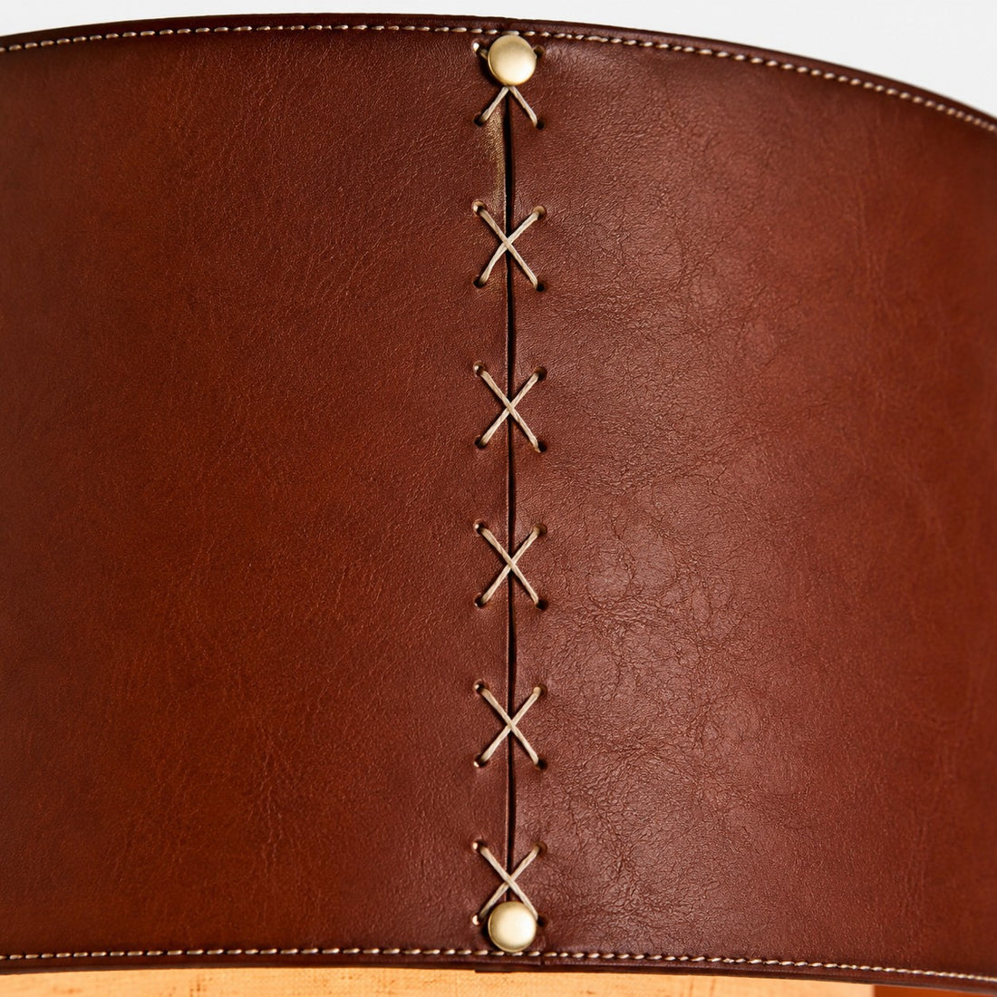 Close-up of brown leather drum shade stitching detail