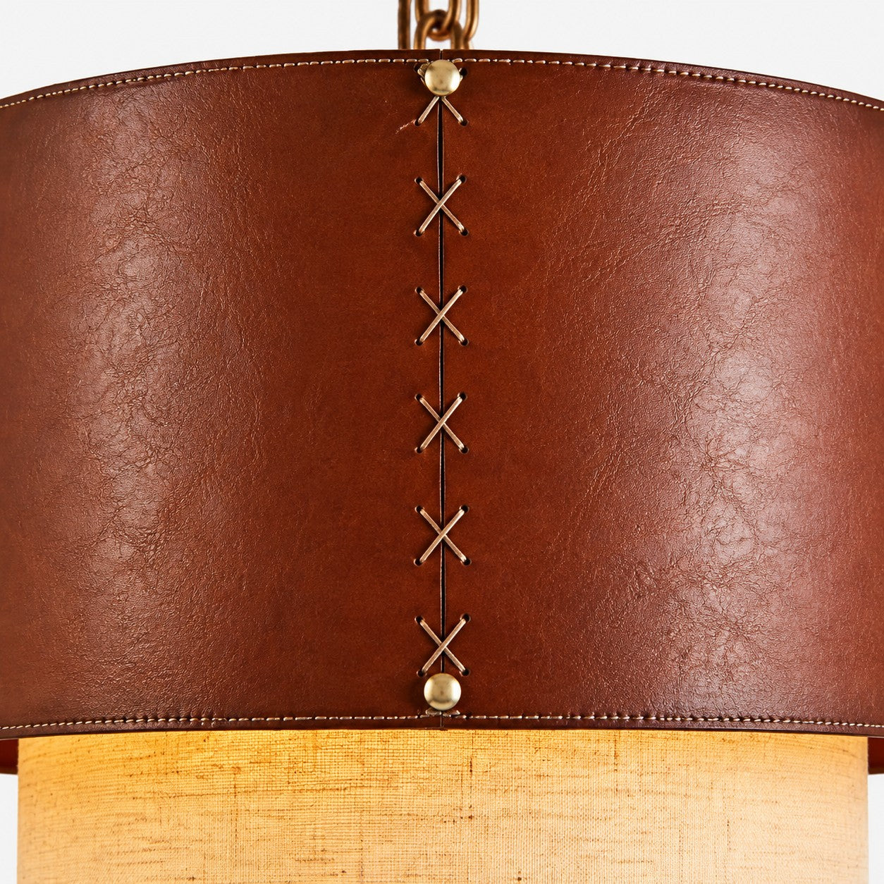 Lower edge detail of brown leather drum pendant shade
