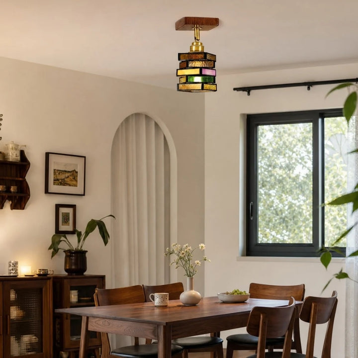 Multicolor glass pendant lamp above a dining table
