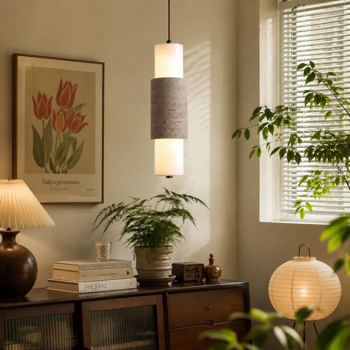 Travertine cylinder pendant lamp installed near a sunny window and console
