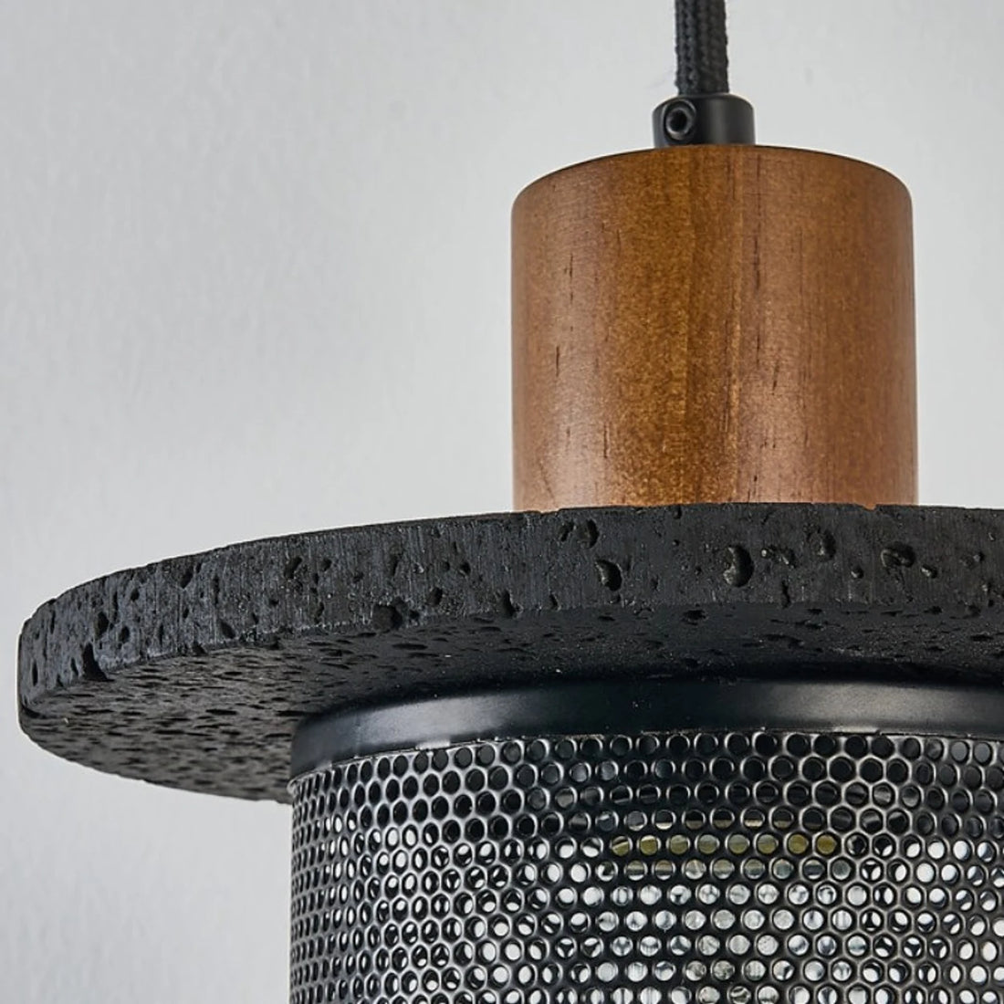 Close detail of the wood cap and black mesh shade connection