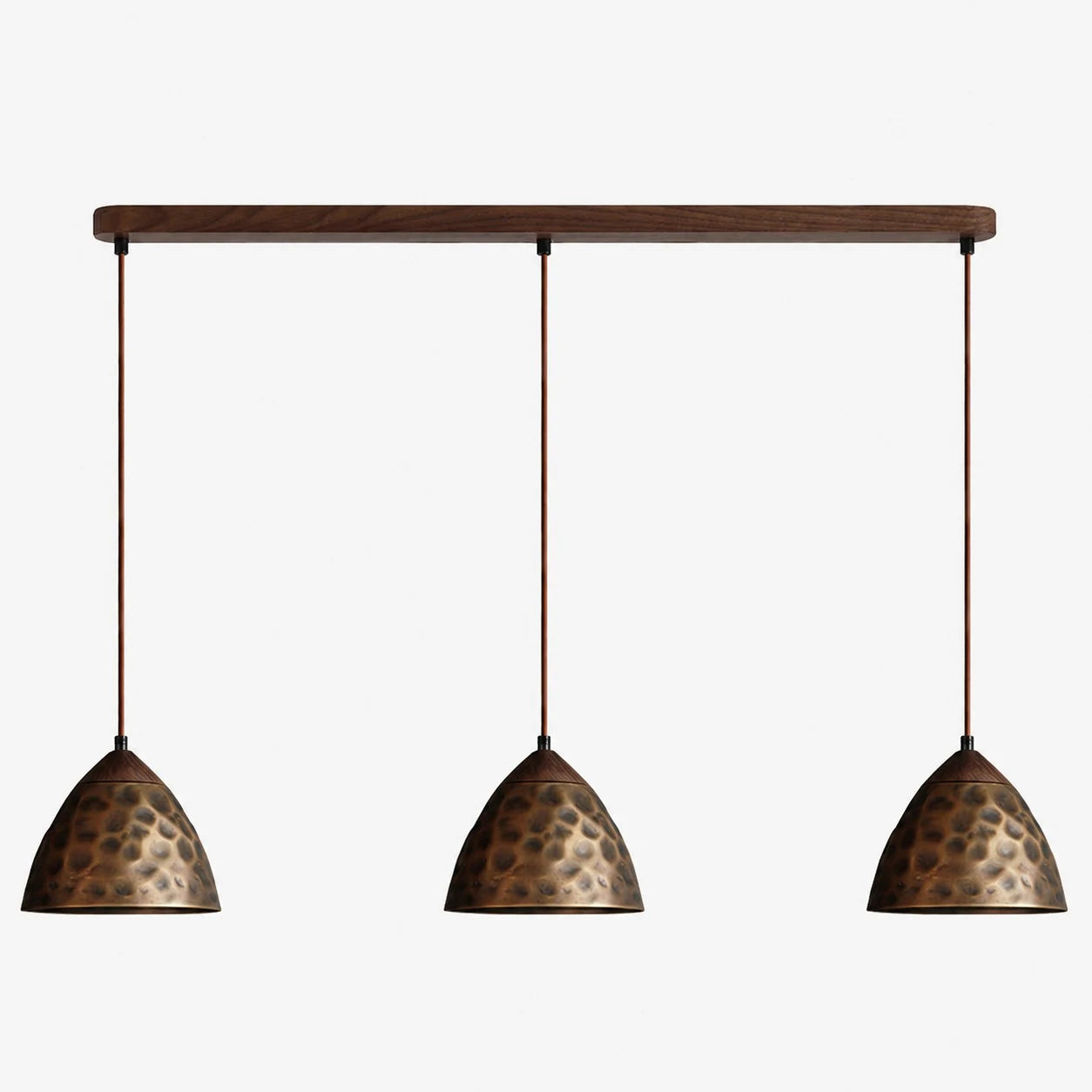 Three-light hammered copper hill pendant on walnut ceiling base