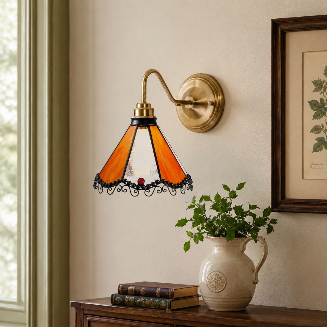 Orange stained glass wall sconce on a framed art wall